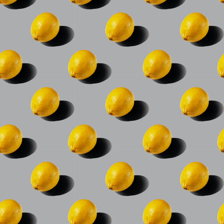 A pattern of whole lemons on a gray background. Healthy food concept. Flat lay.の写真素材