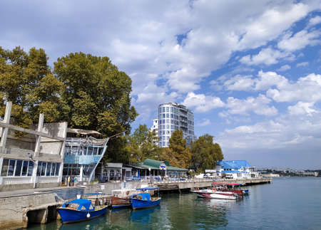 Embankment and pier with boats and boats in Sevastopol in summer. Tourism. September 24, 2020. Mobile photo.のeditorial素材