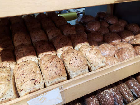 Freshly baked healthy bread with added seeds is on the shelf in the bakery. Fitness bread.