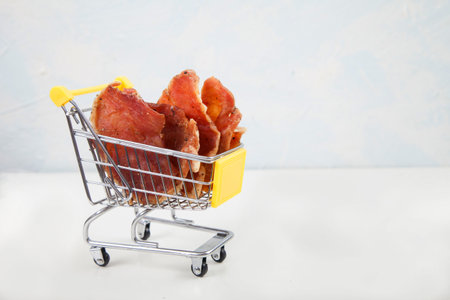 Pieces of jerky are in the grocery cart. Copy spaes.の写真素材