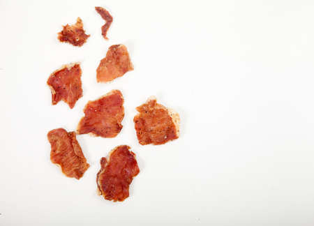 Pieces of jerky on a white plate.の写真素材