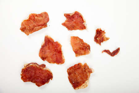 Pieces of jerky on a white plate.の写真素材