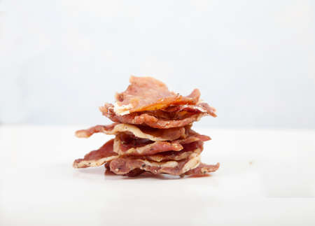 Pieces of jerky are stacked on a white background. Isolate.の写真素材