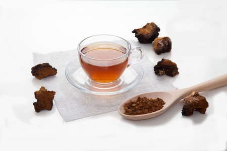 Healthy drink coffee from chaga mushroom in a glass cup on a white background. top view. Copt spaes.の写真素材