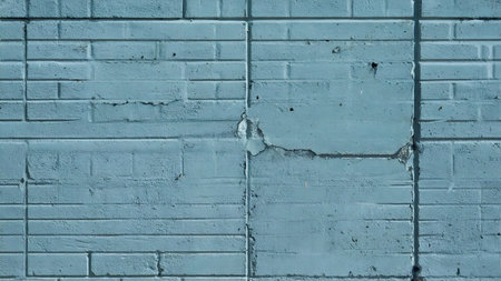 old blue brick wall with peeling paint. background and texture.の素材