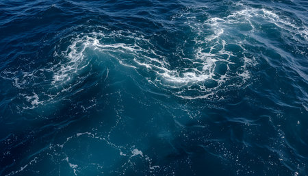 Blue sea water surface with waves and foam. Top view. Natural backgroundの素材