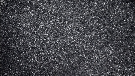 Asphalt texture background. Close up of a black asphalt surface.の素材