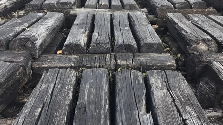 Old wooden walkway in the park, closeup of photo.の素材
