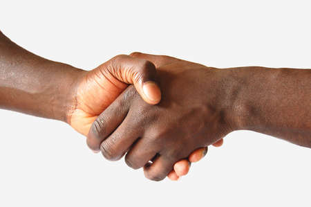 This is an image of two hands performing a left handed, handshake.の写真素材