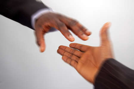 This is an image of a pair of hands reaching out to each other, in speedy motion.の写真素材