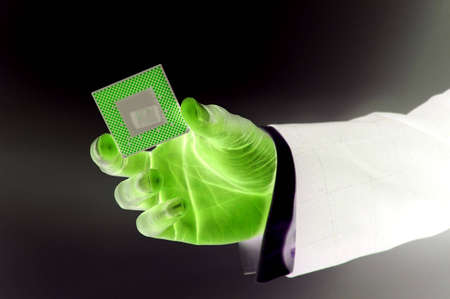 This is an image of hand holding a microprocessor in a 'Digital like' environment.の写真素材