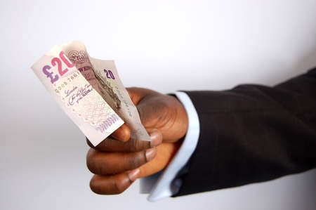 This is an image of a businessman's hand offering 20 pound note.
の写真素材