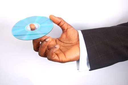 This is an image of a hand holding a cd/dvd disc.の写真素材