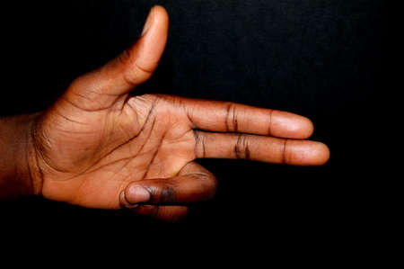 This is an image of a black hand shaped in the form of a gun.