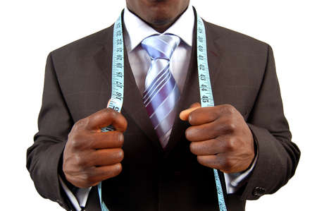 This is an image of a black business man, wearing measuring tape.の写真素材
