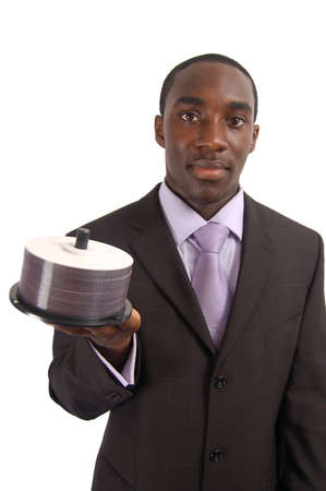This is an image of a business man holding a stack of DVDs/CDs. This can be used to representの写真素材