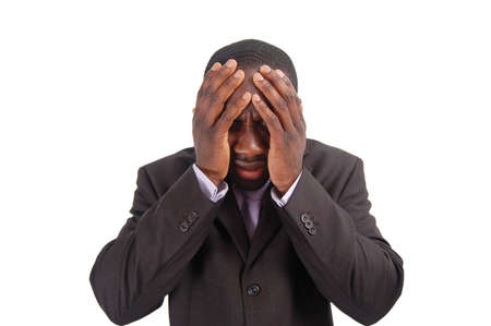 This is an image of a business man with his hands to his head. This image can representの写真素材