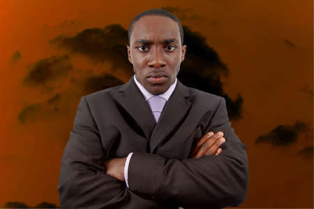 This is an image of a businessman, who is very angry, with a dark cloud behind him.の写真素材