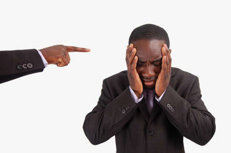 This is an image of a man feeling guilty, with a finger pointing at him.の写真素材