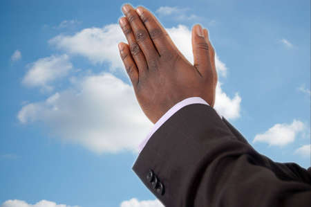 This is an image of businessman with hands in a prayer posture, seekingの写真素材