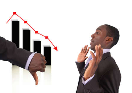 This is an image a hand with thumbs down to indicate that the businessman is responsible for the fall in the graph. Related themes "Stock losses blame", "Bad Investment" etc...の写真素材