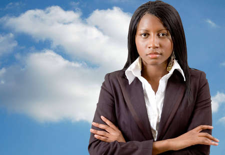 This is an image of a successful business woman with a cloud in the background.の写真素材