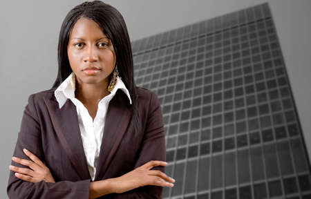 This is an image of a successful business woman with a corporate building in the background.の写真素材