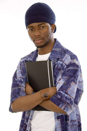 This is an image of a student holding a notepad with his arms crossed. This image can be used to represent student themes.の写真素材