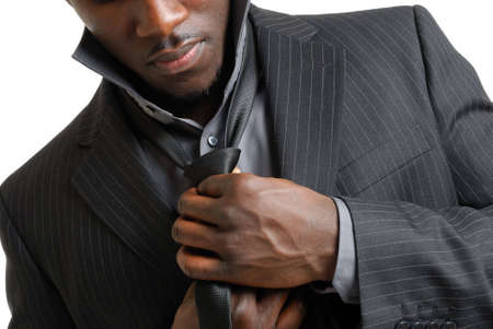 This is an image of business man dressing up and fixing his tieの写真素材