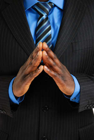 This is an image of business man with his hands put together to show confidence and certainityの写真素材