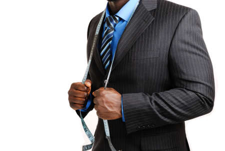 This is an image of business man wearing a tape measure across his suit.の写真素材