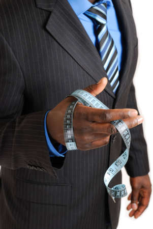 This is an image of business man holding a tape measure.の写真素材