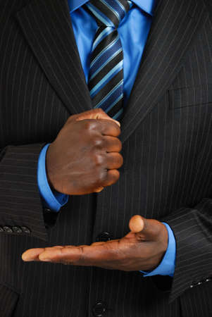 This is an image of a business man about bang his fist into the palm of his hand.の写真素材