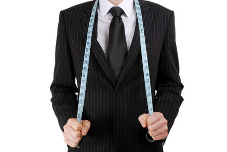 This is an image of business man wearing a tape measure across his suit.の写真素材