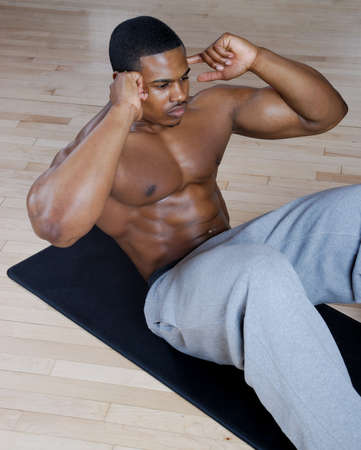 This is an image of a man performing sit ups. の写真素材