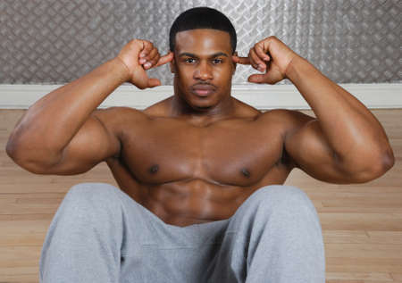 This is an image of a man performing sit ups.の写真素材