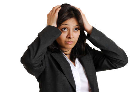 This is an image of a business woman with her hands on her head due to business failure.
