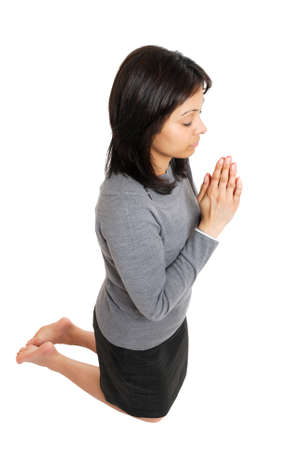 This is an image of business woman kneeling and praying.の写真素材