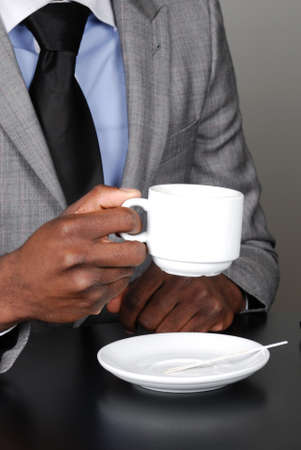 This is an image of a business man holding a cup of coffee.の写真素材