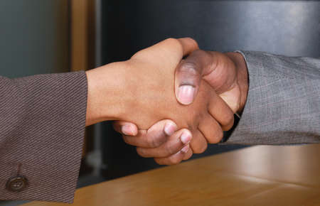 This is an image of male and female handshake at a business reception.の写真素材