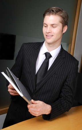 This is an image of a business man holding a book.の写真素材