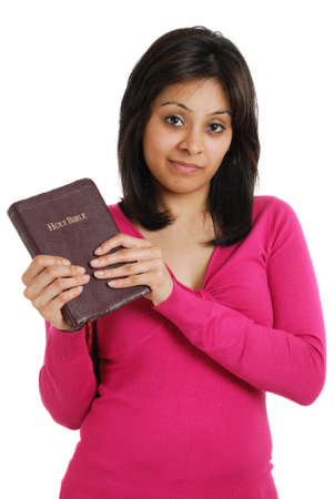 This is an image of female student holding a bible and smiling.の写真素材