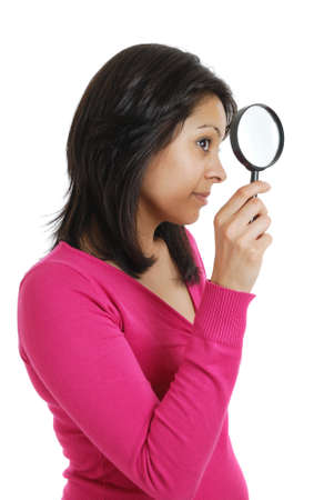 This is an image of female student looking through a magnifying glass.の写真素材