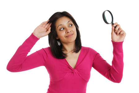 This is an image of female student looking through a magnifying glass.の写真素材