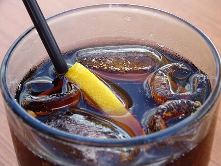 Tasty brown drink with macro structure of ice cubesの写真素材
