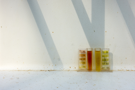 Chlorine test kit for swimming pool test on rusty backgroundの写真素材