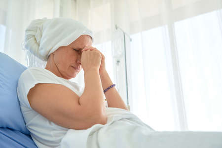 White caucasian female hairless and eyebrowless feel bad are praying and waiting for chemotherapy ...