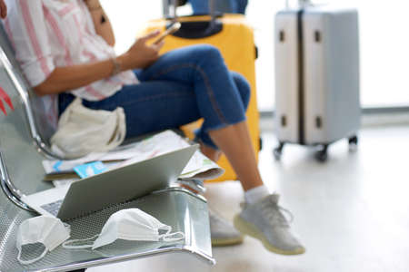 New normal white caucasian couple male - female traveller after corona virus, covid-19 outbreak, Social distancing at international  airport terminalの写真素材