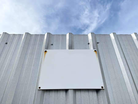 Blank rustic plate metal signs for advertising or artwork with white space patina on metal sheet fender on blue sky.の写真素材