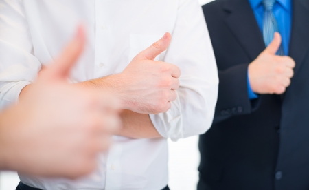 Businessmen gesturing thumbs upの写真素材